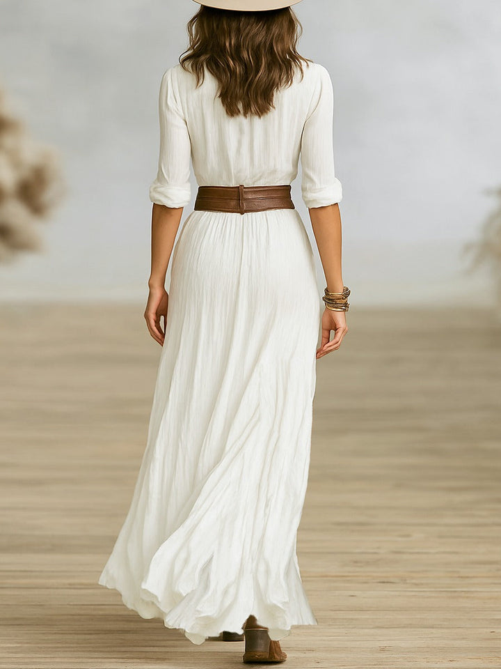 Robe longue ceinturée à revers plissés